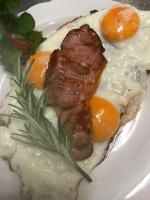 a plate of food with meat and eggs on it at Pension Karina Schwerin in Schwerin
