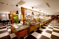 a restaurant with a long counter in a room at Kindness Hotel - Kaohsiung Main Station in Kaohsiung