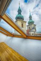 a view from a window of a church with two domes at Residence St Havel Prague Old Town in Prague