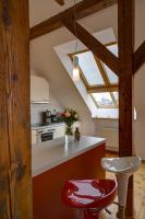 a kitchen with a red stool and a window at Residence St Havel Prague Old Town in Prague