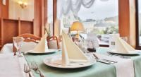 a table with white plates with napkins on it at Olympia Wellness Hotel in Karlovy Vary