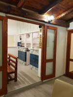 a kitchen with a wooden door and a table at Hotel Galia in Kotor