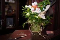a vase of flowers sitting on top of a table at Magus Hotel in Baia Mare