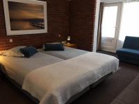 Een bed of bedden in een kamer bij Hotel 't Witte Huys Scheveningen