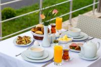 a table with breakfast foods and orange juice on it at Gabala Yengice Thermal Resort Hotel in Yengica