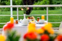 a table with a plate of food and glasses of orange juice at Gabala Yengice Thermal Resort Hotel in Yengica