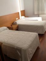 A bed or beds in a room at Hostal El Poligono