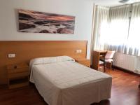 A bed or beds in a room at Hostal El Poligono
