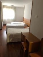 A bed or beds in a room at Hostal El Poligono