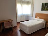 A bed or beds in a room at Hostal El Poligono