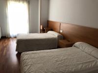 A bed or beds in a room at Hostal El Poligono