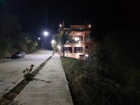 a building on a street at night at Casa Arcoiris Zihuatanejo B&B in Zihuatanejo