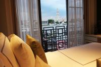 a room with a balcony with a view of the river at Riva Arun Bangkok in Bangkok