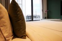a bed with two pillows in a room with a window at Riva Arun Bangkok in Bangkok