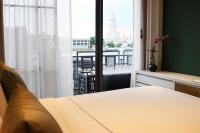 a bedroom with a bed and a window with a view at Riva Arun Bangkok in Bangkok