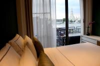 a bedroom with a bed and a window with a view at Riva Arun Bangkok in Bangkok