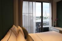 a bedroom with a bed and a window with a view at Riva Arun Bangkok in Bangkok