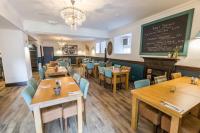 a restaurant with wooden tables and chairs and a chalkboard at The Torfin in Edinburgh