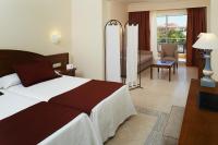 a hotel room with a bed and a living room at Hipotels Barrosa Garden in Chiclana de la Frontera