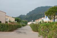 a street in a town with a mountain in the background at Résidence Niccola in Vidauban
