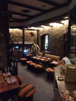 a man standing in a restaurant with tables and chairs at Fortune Resort Heevan, Srinagar - Member ITC Hotels' Group in Srinagar
