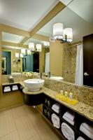 a bathroom with a sink and a large mirror at Crowne Plaza Chicago O'Hare Hotel & Conference Center by IHG in Rosemont