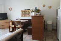 a kitchen with a desk and a table with a chair at Holiday Home by the Sea in Nea Potidaea