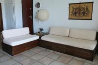two benches in a living room with white cushions at Holiday Home by the Sea in Nea Potidaea