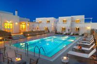 Una piscina frente a una villa por la noche. en Perigiali, en Skiros