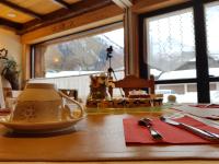 a table with a cup and a tea pot on it at Auberge du Manoir in Chamonix