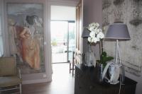 a room with a dresser with a lamp and flowers on it at Logis Saint-Léonard in Honfleur