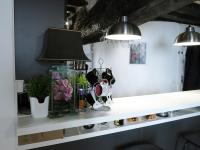 a shelf with a lamp and some bottles on it at Studio Marais Charlot CityCosy in Paris