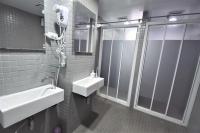a bathroom with a sink and a shower at Inn Cube - Taipei Main Station in Taipei