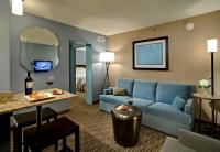 a living room with a blue couch in a hotel room at Crowne Plaza Chicago O'Hare Hotel & Conference Center by IHG in Rosemont