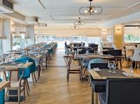 a dining room filled with tables and chairs at H10 Delfín - Adults Only in Salou