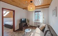Televízia a/alebo spoločenská miestnosť v ubytovaní Apartamenty Zdrojowa