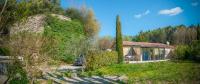 a house in the middle of a yard with trees at A jewel by the river! in Fontaine-de-Vaucluse