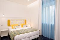a white bedroom with a bed and a window at Hotel Nice in Sorrento
