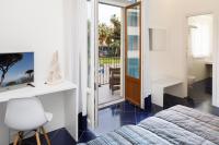 a bedroom with a bed and a desk and a mirror at Hotel Nice in Sorrento