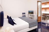 a bedroom with a white bed and a window at Hotel Nice in Sorrento