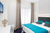 a bedroom with a large bed with blue pillows at Hotel Nice in Sorrento