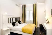 a hotel room with a bed with a yellow blanket at Hotel Nice in Sorrento