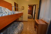 a bedroom with a bunk bed and a desk and a bed at Hotel Villa Ruscello in Baveno