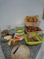 a table with bread and baskets of food on it at Hotel Asterra in Saalfeld