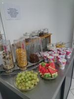 a counter with plates of food and bowls of fruit at Hotel Asterra in Saalfeld