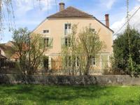 a house with a fence in front of a yard at Beautiful country house with enclosed garden in green surroundings in Burgundy in Bouix