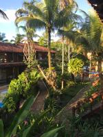 a resort with palm trees and a swimming pool at Hotel Pousada Marambaia in Arraial d'Ajuda