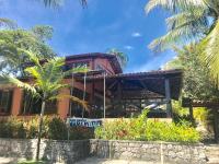 a resort with palm trees in front of it at Hotel Pousada Marambaia in Arraial d'Ajuda