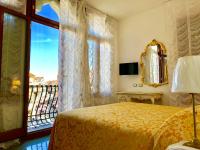 a bedroom with a bed and a window with a balcony at Hotel Marte in Venice