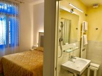 a bathroom with a bed and a sink and a mirror at Hotel Marte in Venice